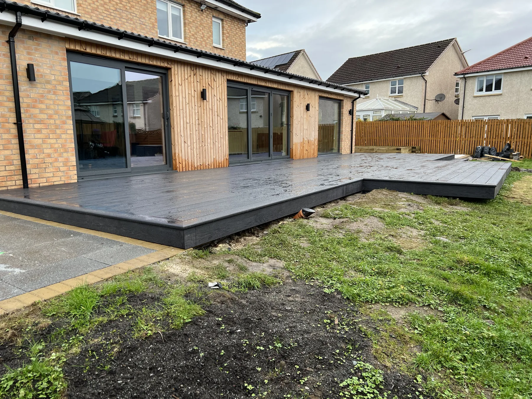 Rear extension with broad glazed doors and a newly built deck